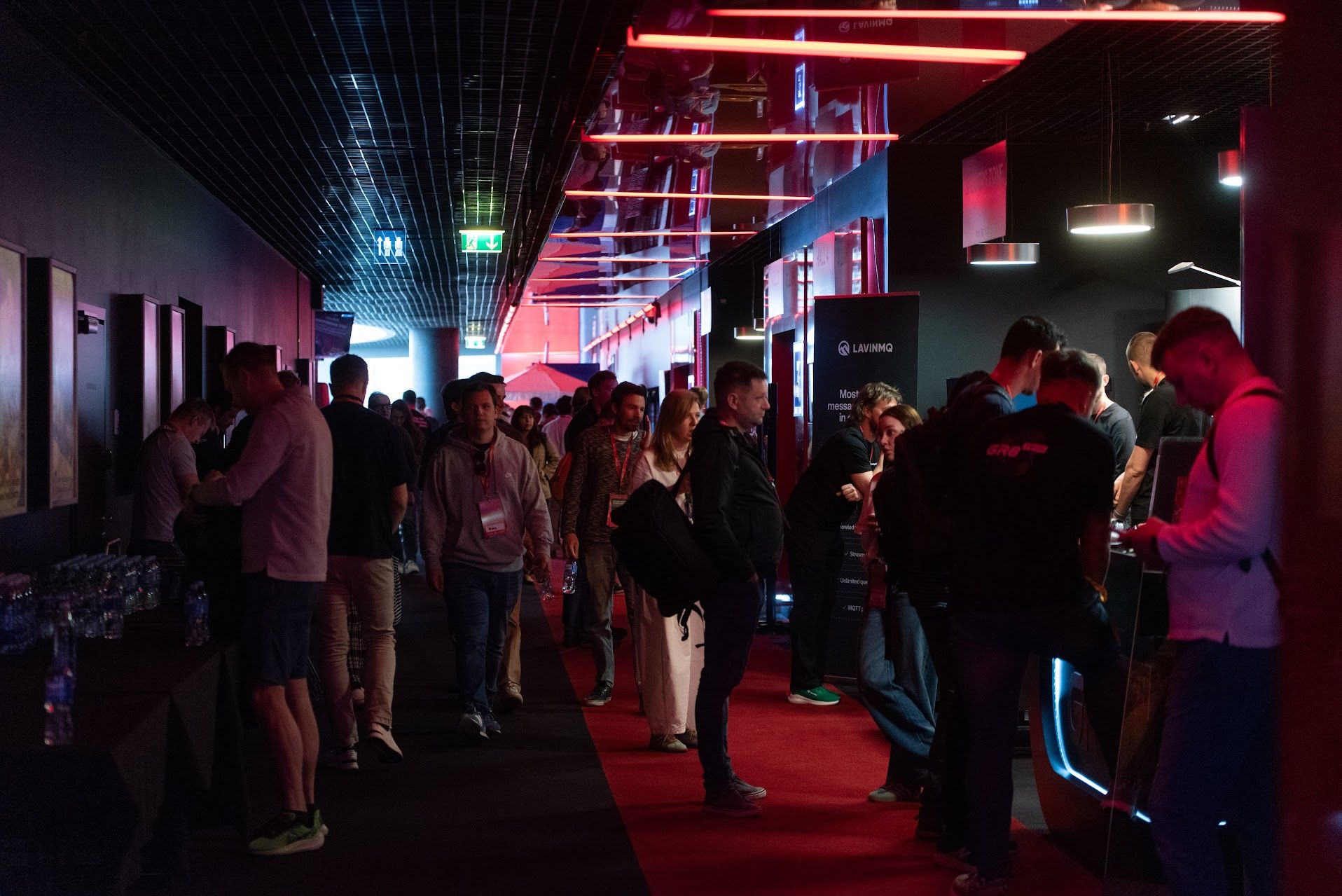 Dark, crowded movie theater hallway of the conference.
